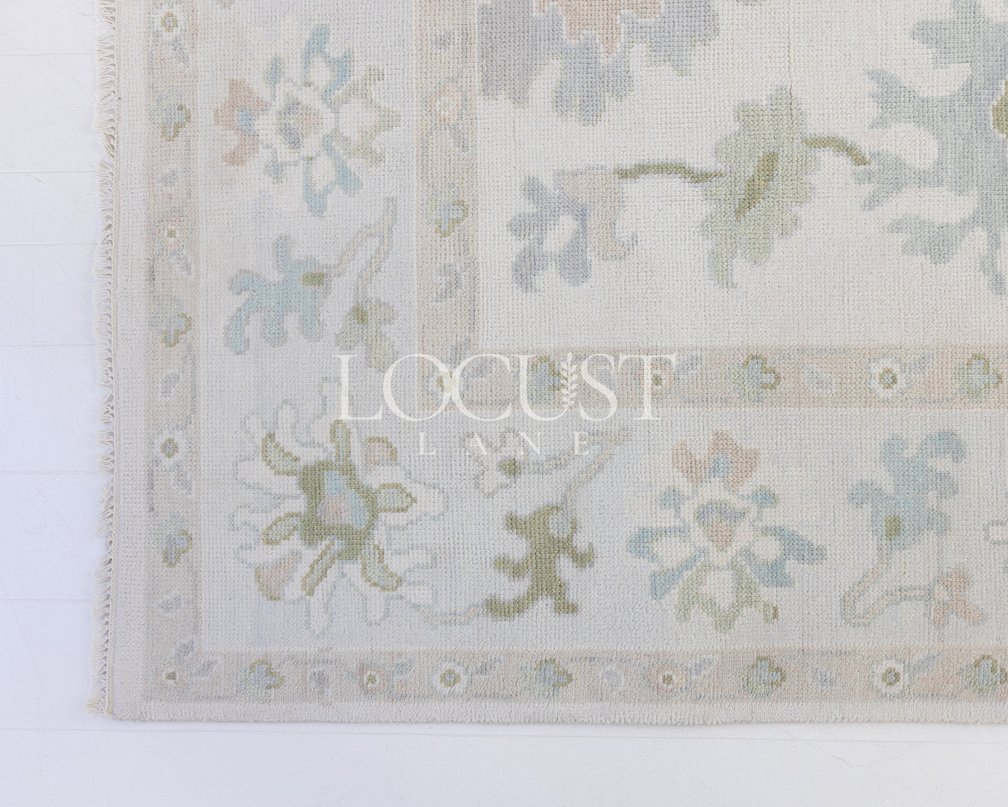 Opal hand-knotted wool rug in soft blue, blush, olive, and ivory from Locust Lane Rugs