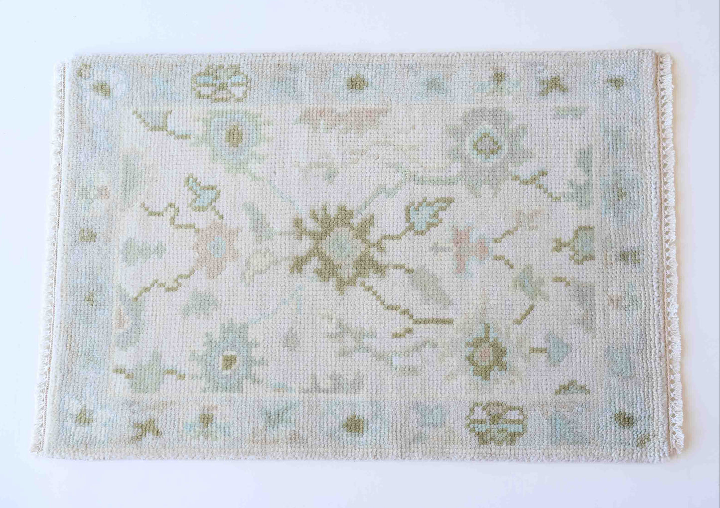 Hand-knotted wool rug with soft floral motifs in pale blue, sage, and ivory – Opal Mini Rug by Locust Lane Rugs