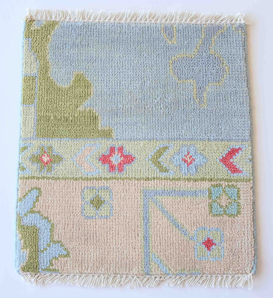 Handknotted wool rug sample in blue, blush, olive, and coral with traditional border design – Clementine Rug Sample by Locust Lane Rugs