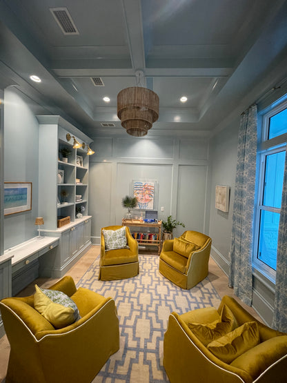 Della hand-knotted wool rug in blue, ivory, and chartreuse from Locust Lane Rugs. Styled in a study.