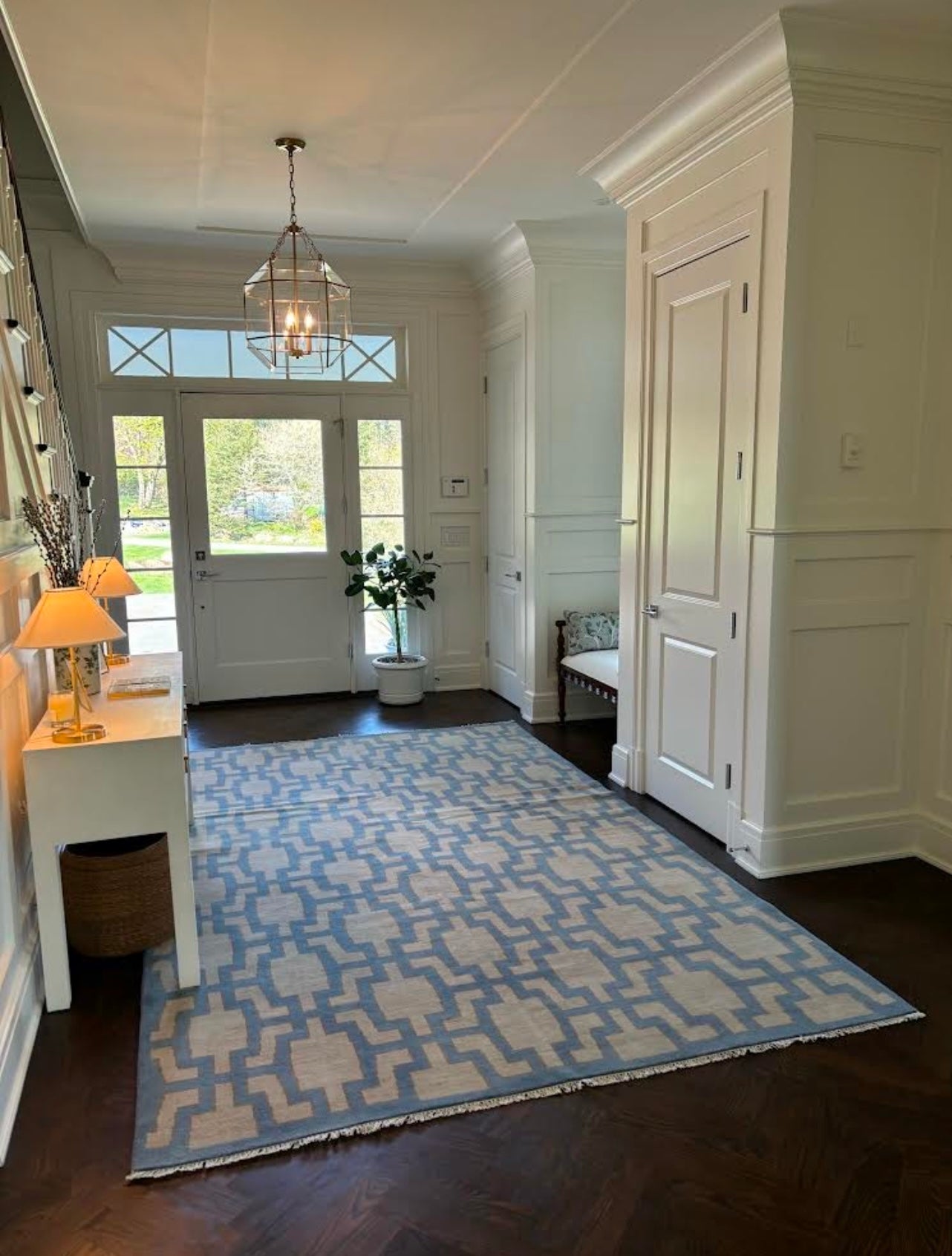 Della hand-knotted wool rug in blue, ivory, and chartreuse from Locust Lane Rugs. In an entryway.
