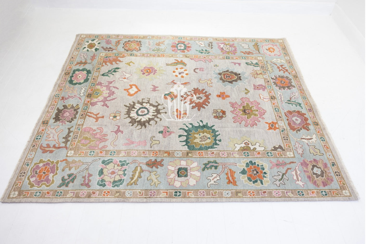 Decorative rug with floral and geometric patterns on a light background