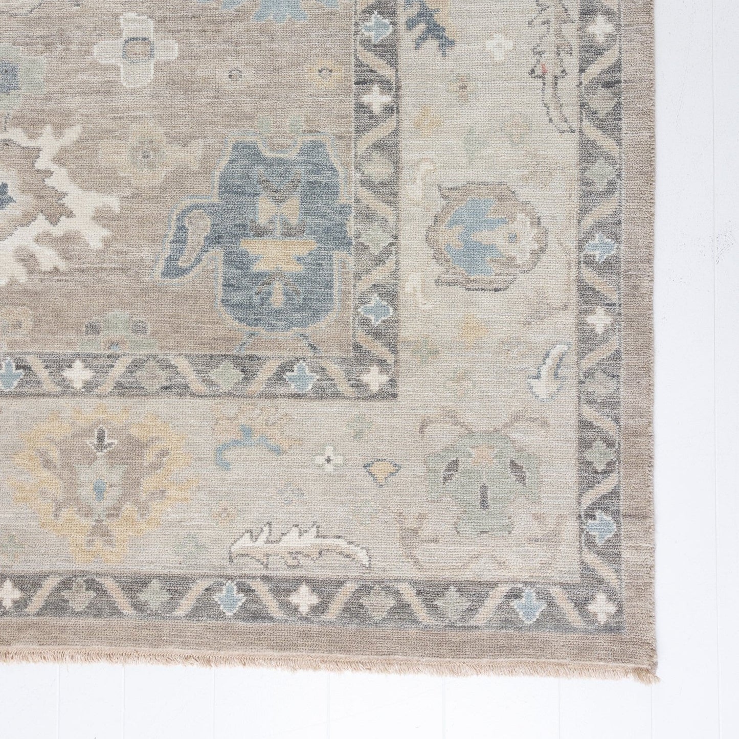 soft tones of beige, blue and grey hand knotted rug