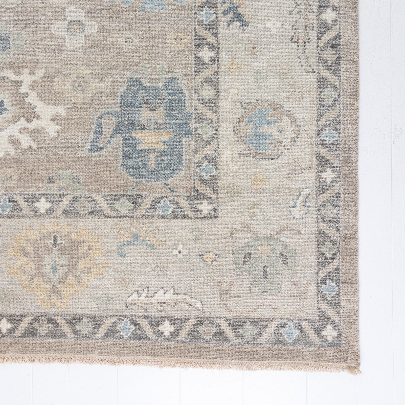 soft tones of beige, blue and grey hand knotted rug