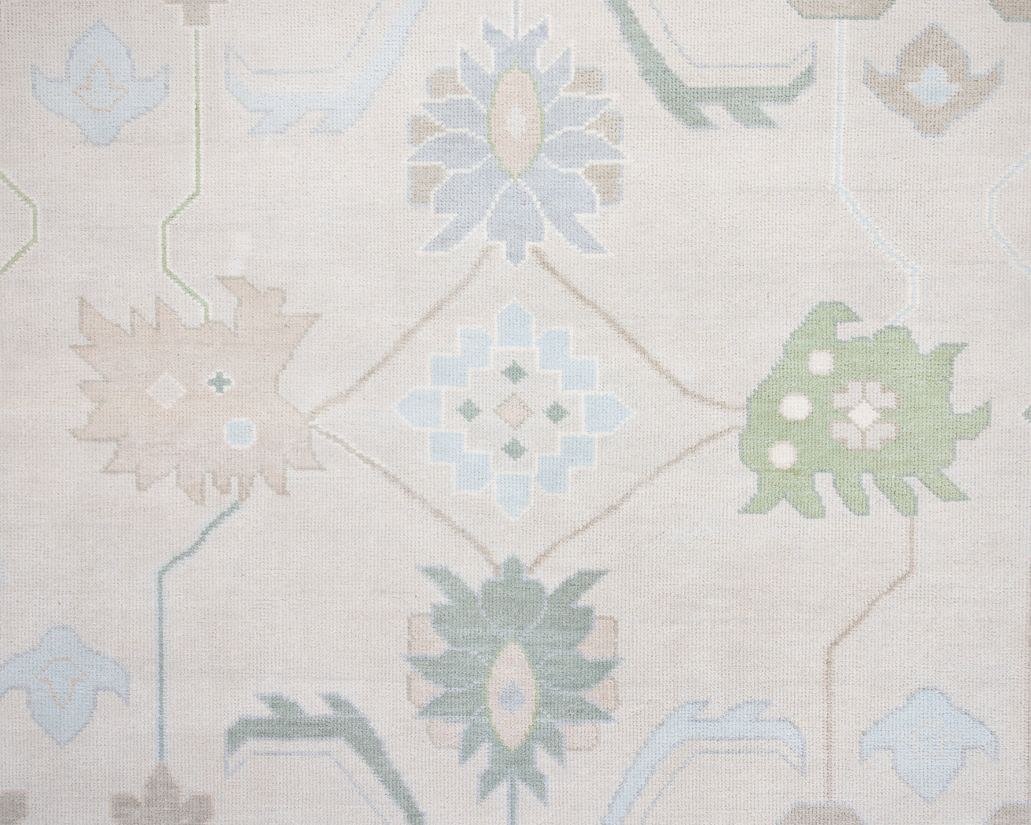 Fiona hand-knotted wool Oushak rug in ivory and faded blue from Locust Lane Rugs.