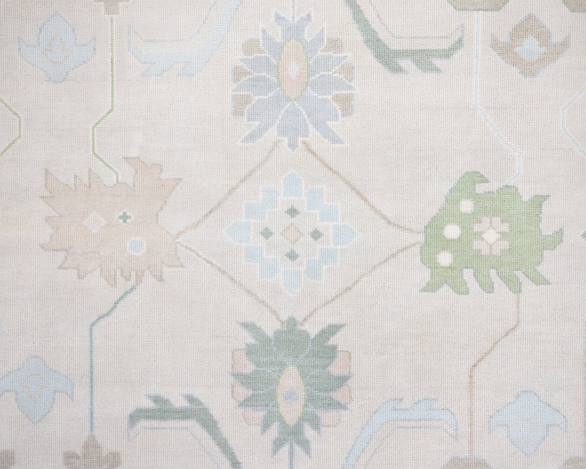 Fiona hand-knotted wool Oushak rug in ivory and faded blue from Locust Lane Rugs.
