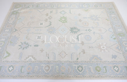 Fiona hand-knotted wool Oushak rug in ivory and faded blue from Locust Lane Rugs.
