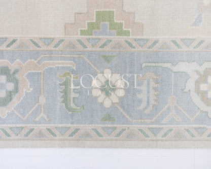 Fiona hand-knotted wool Oushak rug in ivory and faded blue from Locust Lane Rugs.