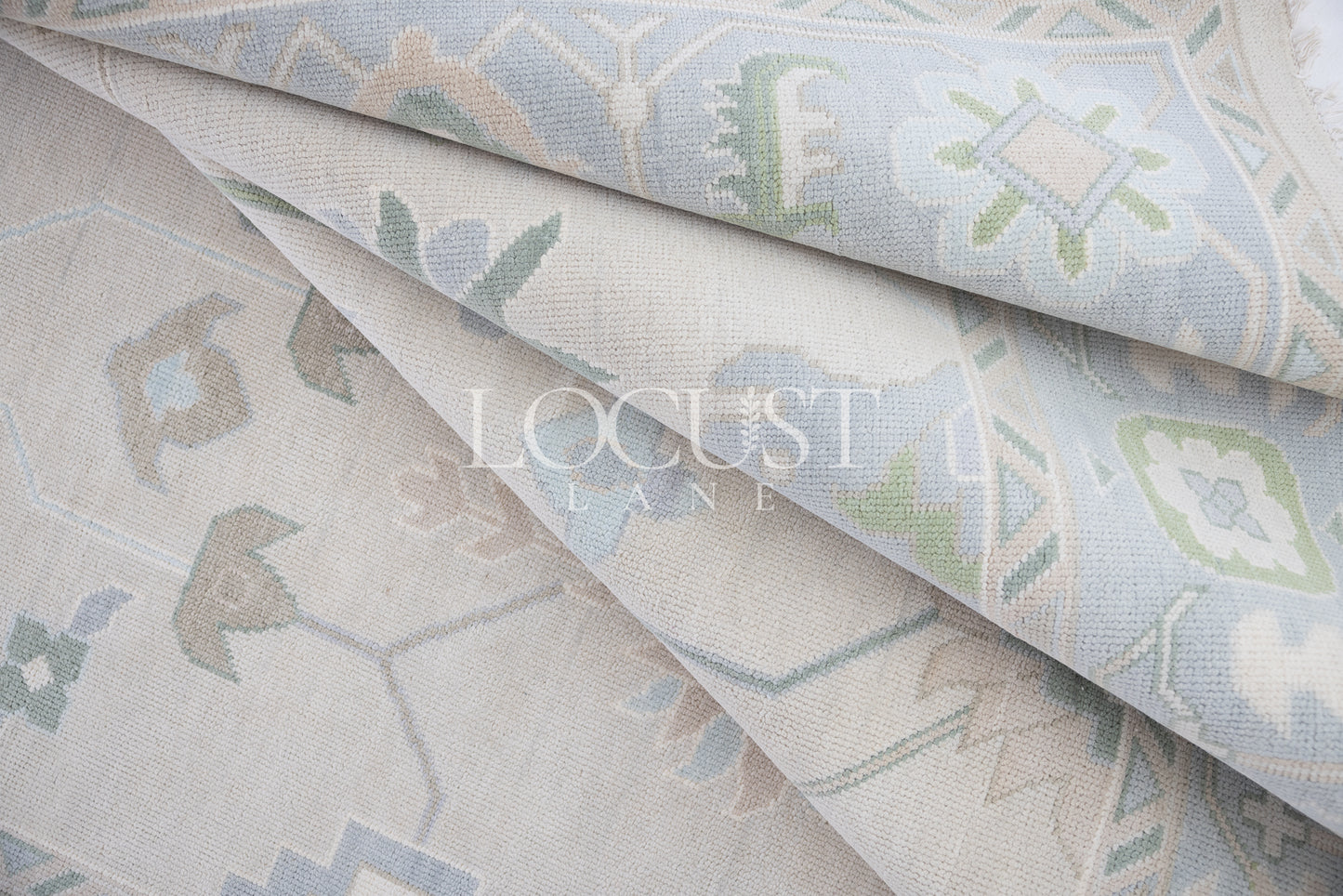 Fiona hand-knotted wool Oushak rug in ivory and faded blue from Locust Lane Rugs.