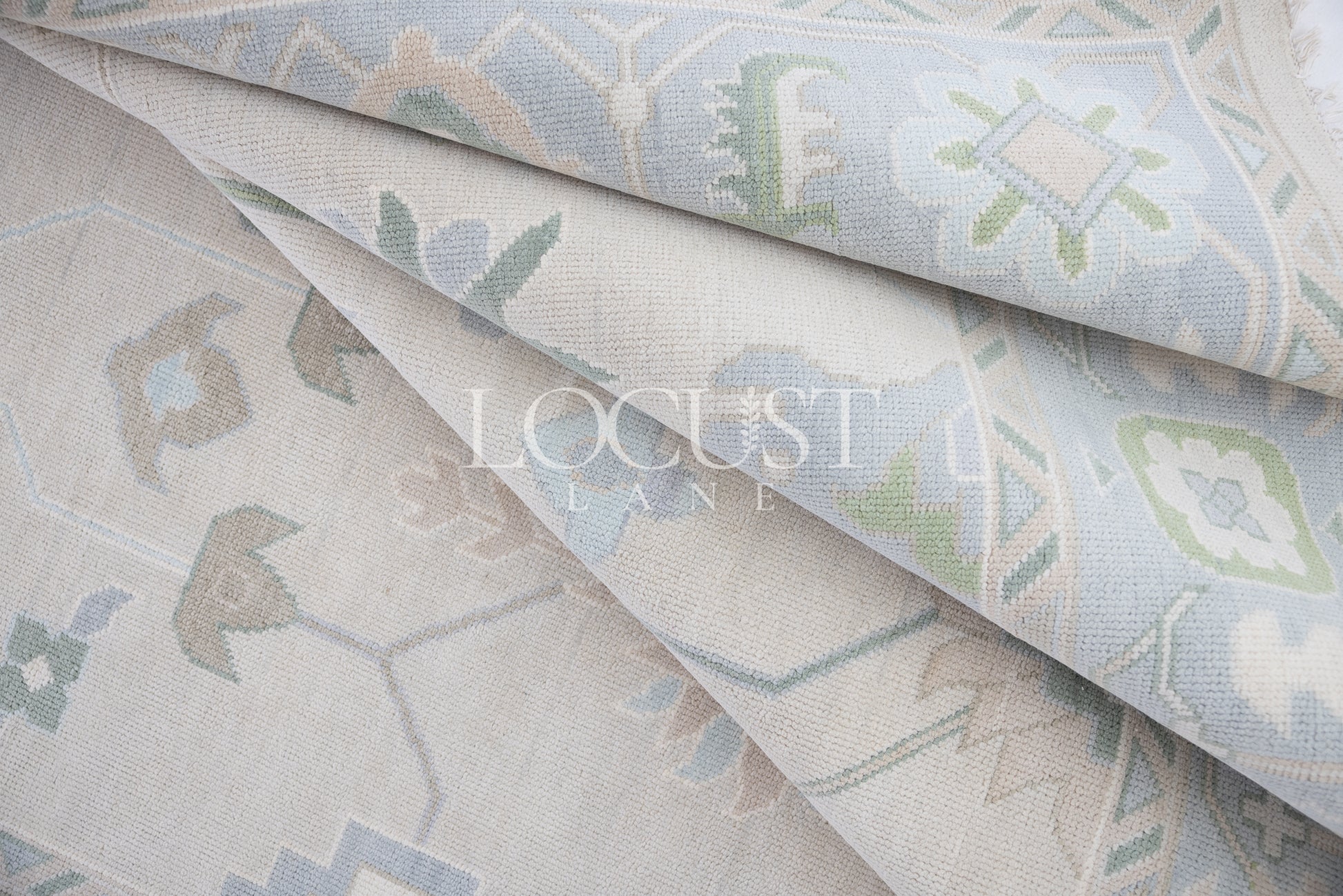 Fiona hand-knotted wool Oushak rug in ivory and faded blue from Locust Lane Rugs.