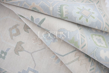 Fiona hand-knotted wool Oushak rug in ivory and faded blue from Locust Lane Rugs.