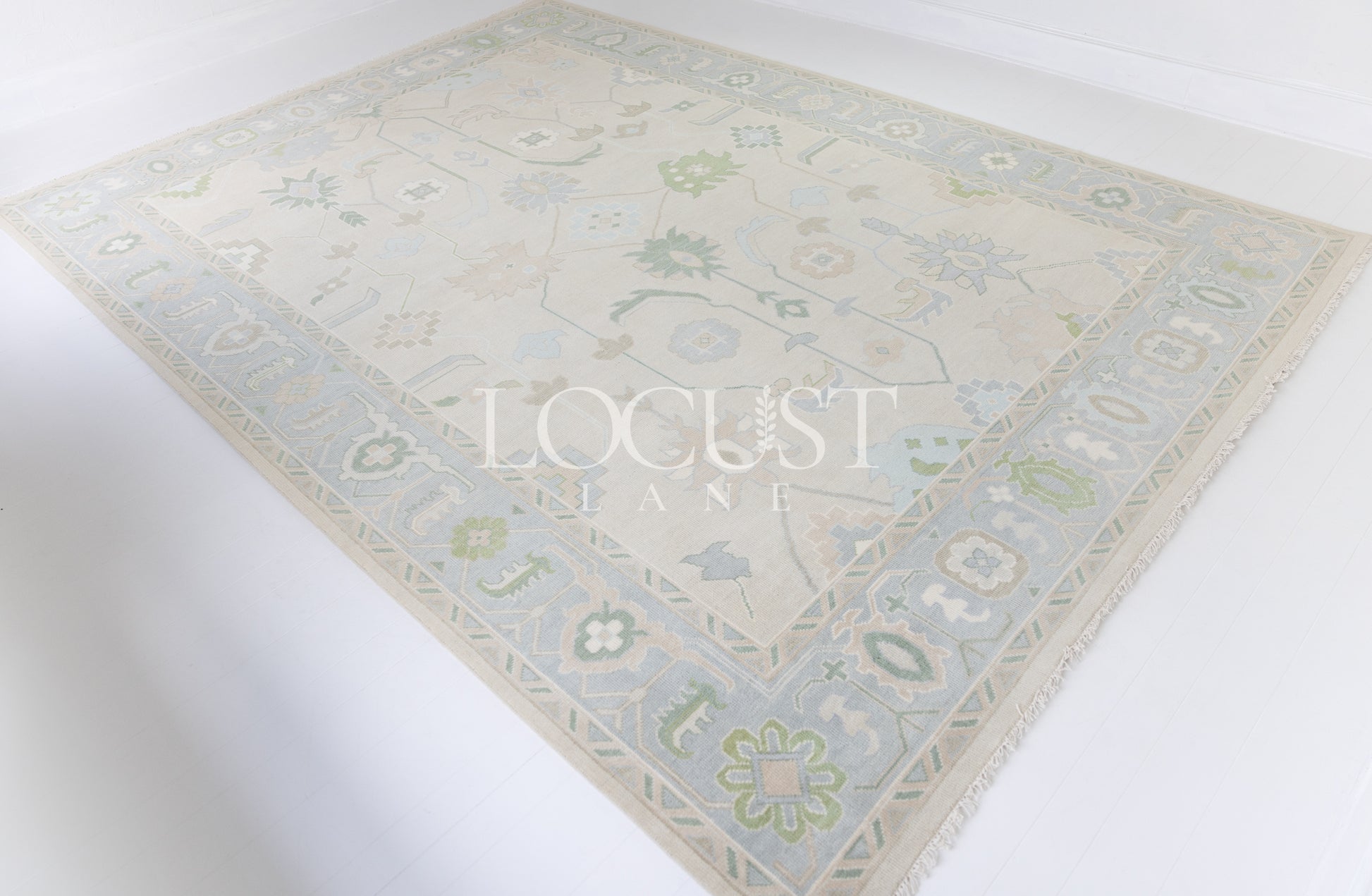 Fiona hand-knotted wool Oushak rug in ivory and faded blue from Locust Lane Rugs.