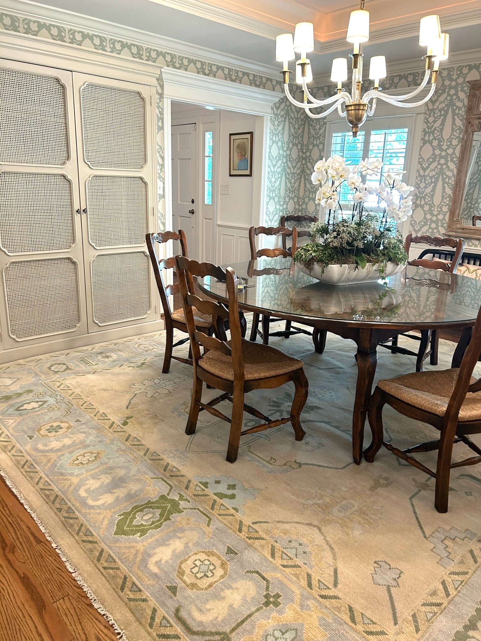 Fiona hand-knotted wool Oushak rug in ivory and faded blue from Locust Lane Rugs in a dining room