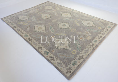 purplish grey hand knotted rug with pastel 