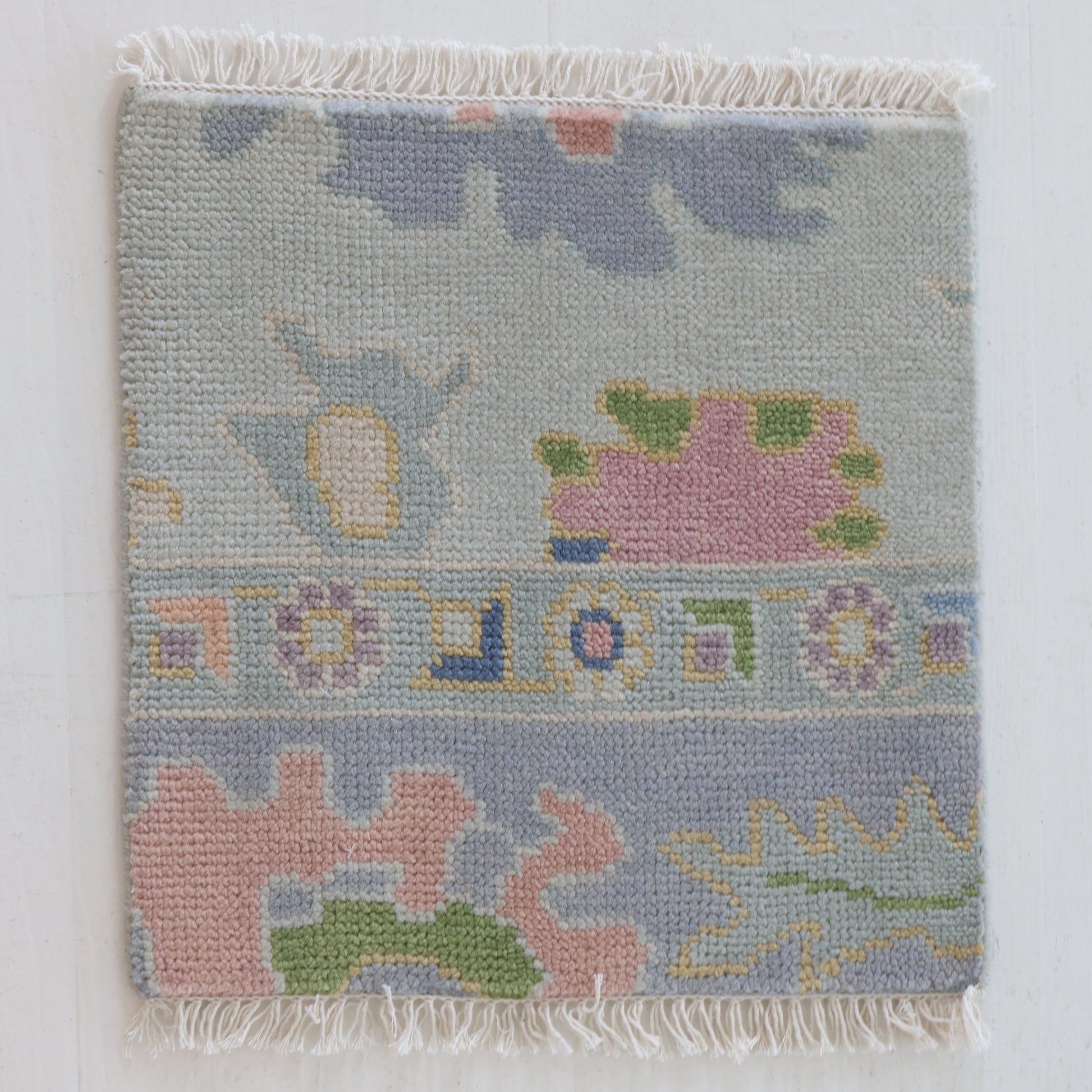 Handknotted wool rug sample in pastel blue, blush, and sage geometric floral pattern – June Rug Sample by Locust Lane Rugs