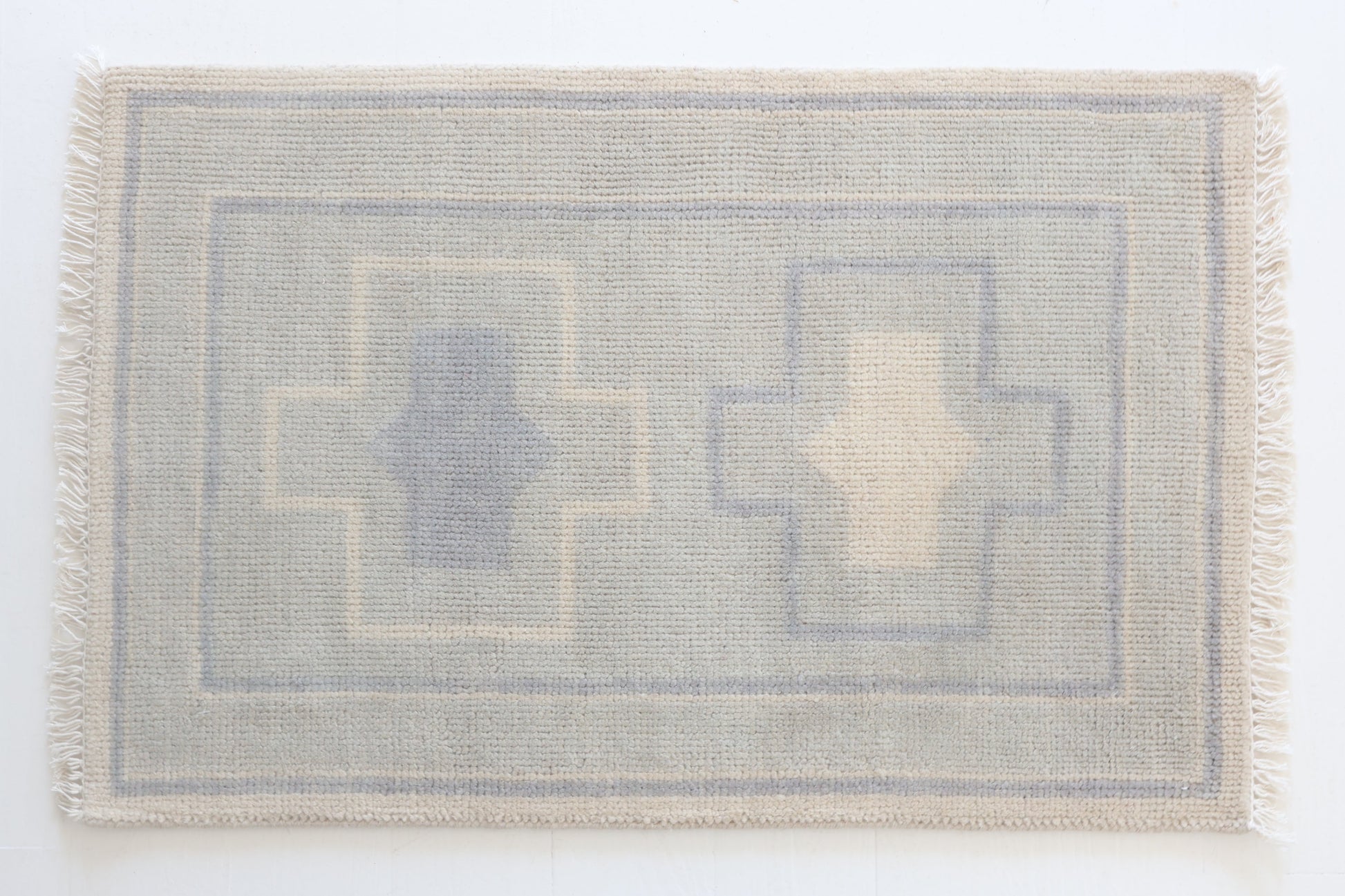 Hand-knotted wool rug with geometric cross design in soft blue and cream – Loretta Mini Rug by Locust Lane Rugs