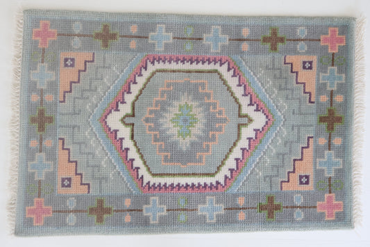 Hand-knotted wool rug featuring a geometric medallion design in soft sky blue, blush, olive, and lavender tones – Maisie Rug by Locust Lane Rugs