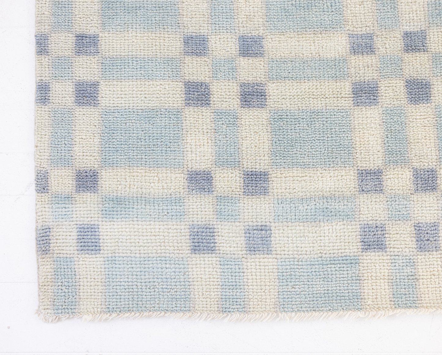 Checkered pattern with blue and beige squares on a white background