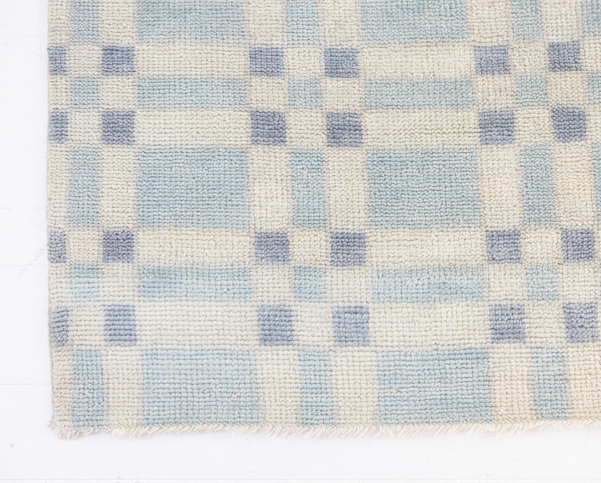 Checkered pattern with blue and beige squares on a white background