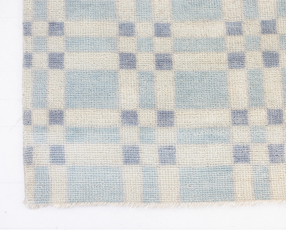 Checkered pattern with blue and beige squares on a white background