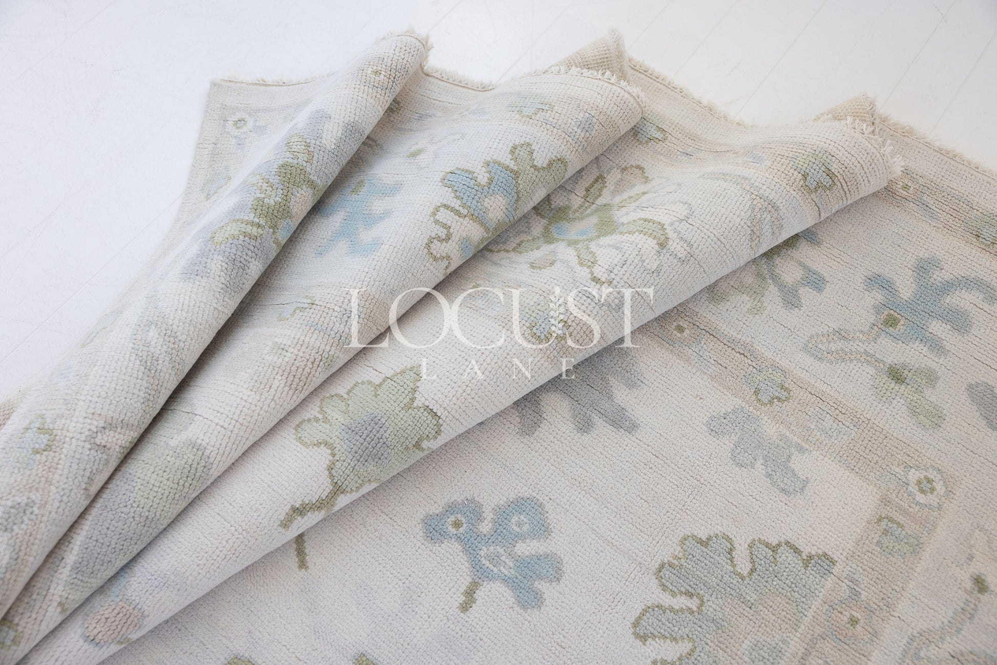 Opal hand-knotted wool rug in soft blue, blush, olive, and ivory from Locust Lane Rugs