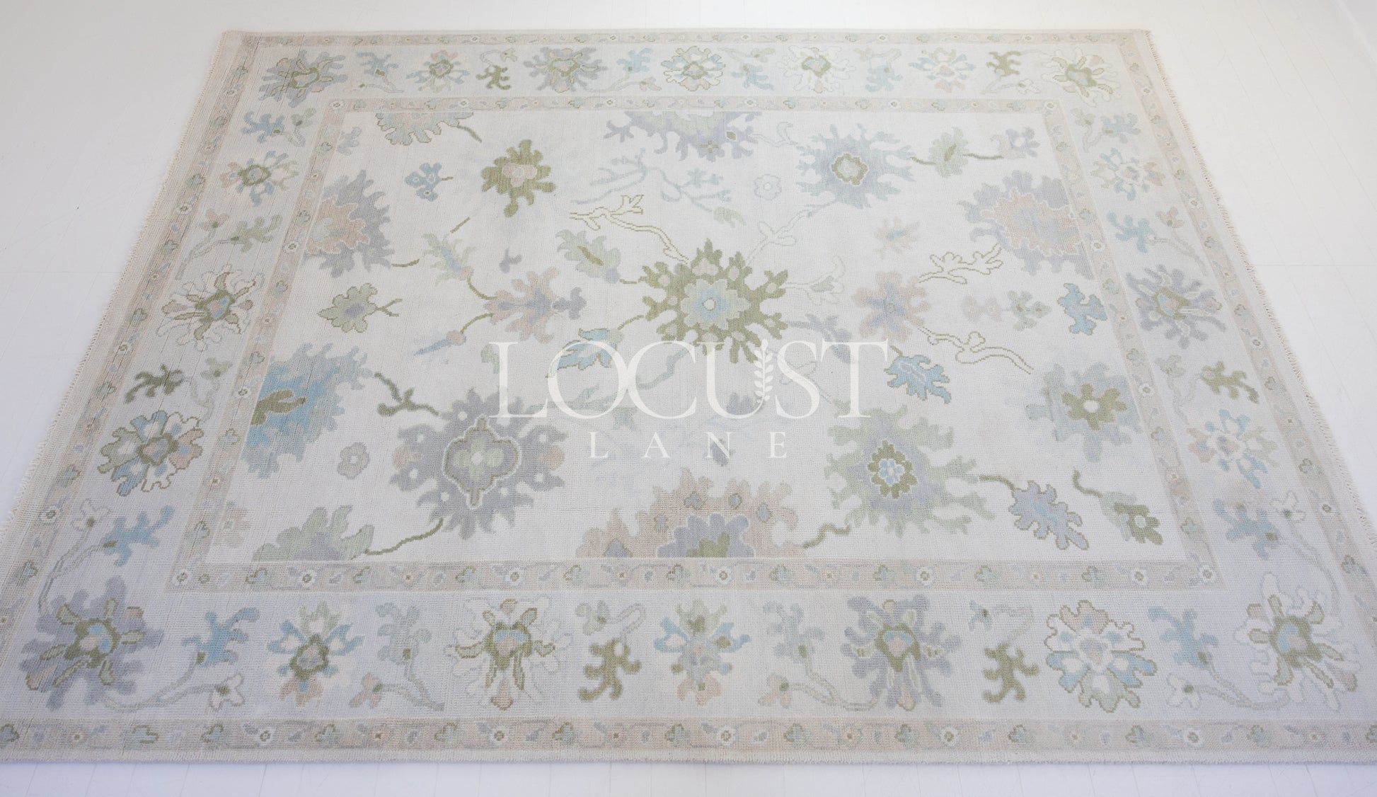 Opal hand-knotted wool rug in soft blue, blush, olive, and ivory from Locust Lane Rugs