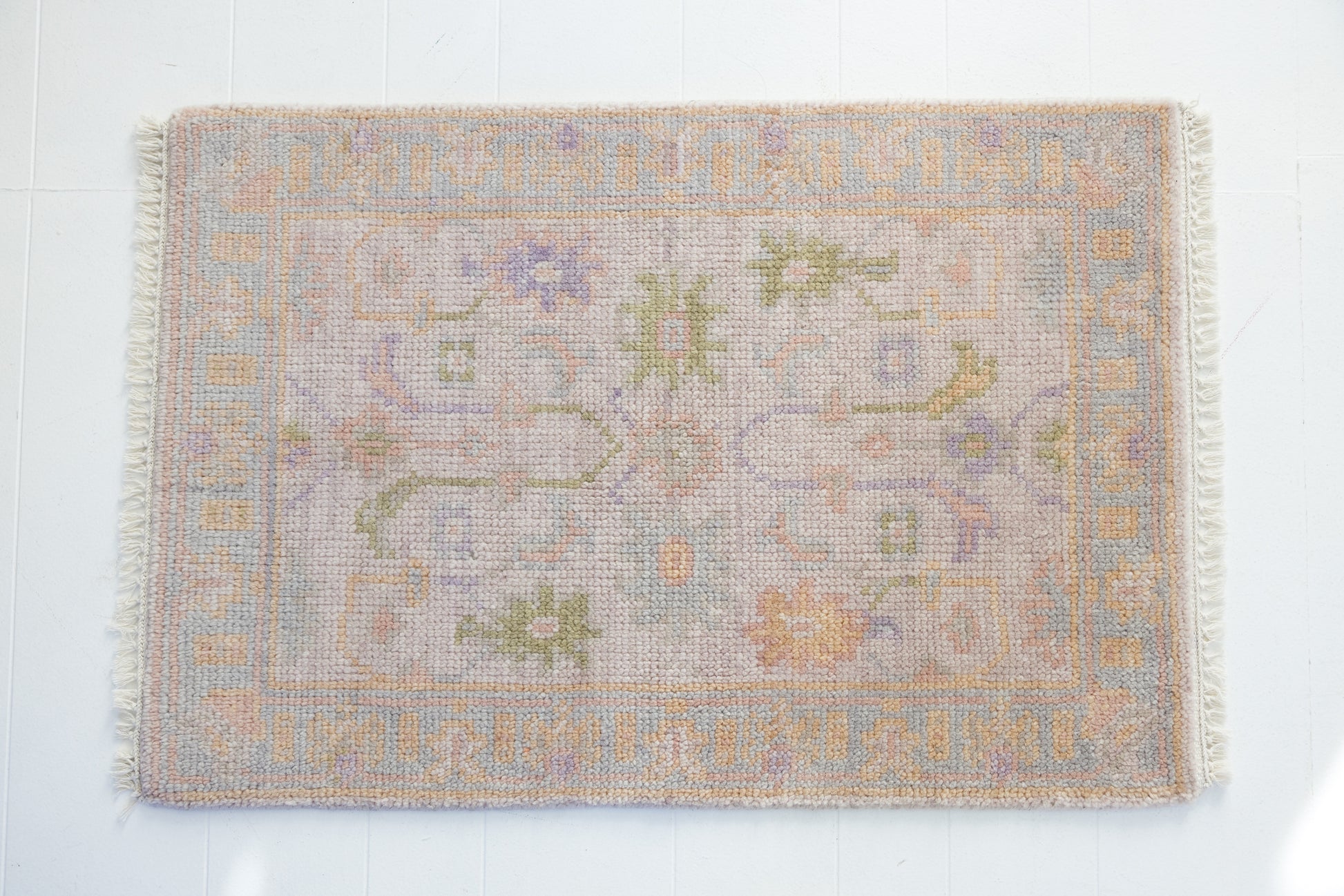 Hand-knotted wool rug with traditional Oushak design in soft blush, lavender, sage, and ivory – Rose Mini Rug by Locust Lane Rugs