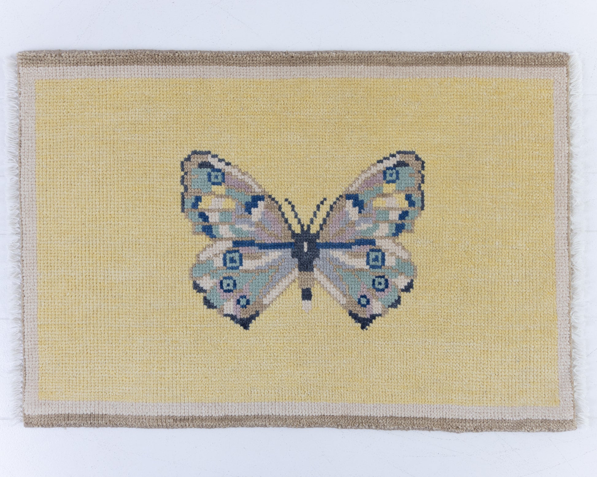 Hand-knotted wool rug featuring a butterfly motif on a buttercream yellow background with ivory border – Yellow Butterfly Mini Rug by Locust Lane Rugs