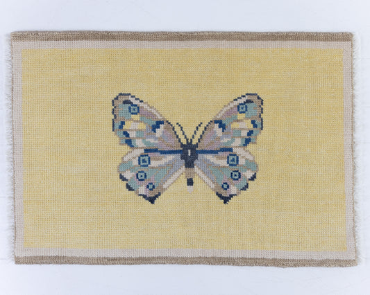 Hand-knotted wool rug featuring a butterfly motif on a buttercream yellow background with ivory border – Yellow Butterfly Mini Rug by Locust Lane Rugs