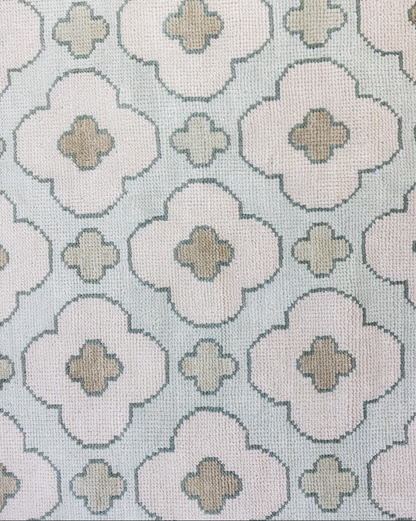 Hand-knotted wool rug featuring geometric patterning in warm taupe, clay, and ivory tones. The Cricket Rug from Locust Lane blends earthy color and artisan texture for a timeless, collected look.
