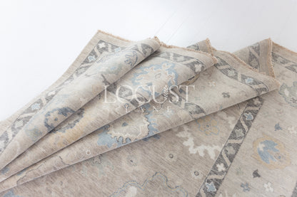 soft tones of beige, blue and grey hand knotted rug