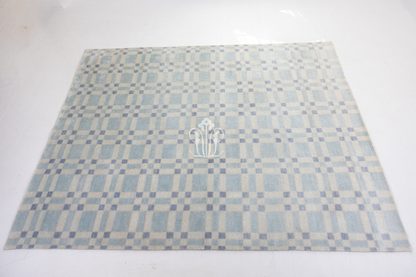 Checkered patterned rug with a logo on a white background