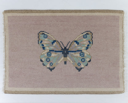 Hand-knotted wool rug featuring a butterfly motif on a soft mauve background with ivory border – Mauve Butterfly Mini Rug by Locust Lane Rugs