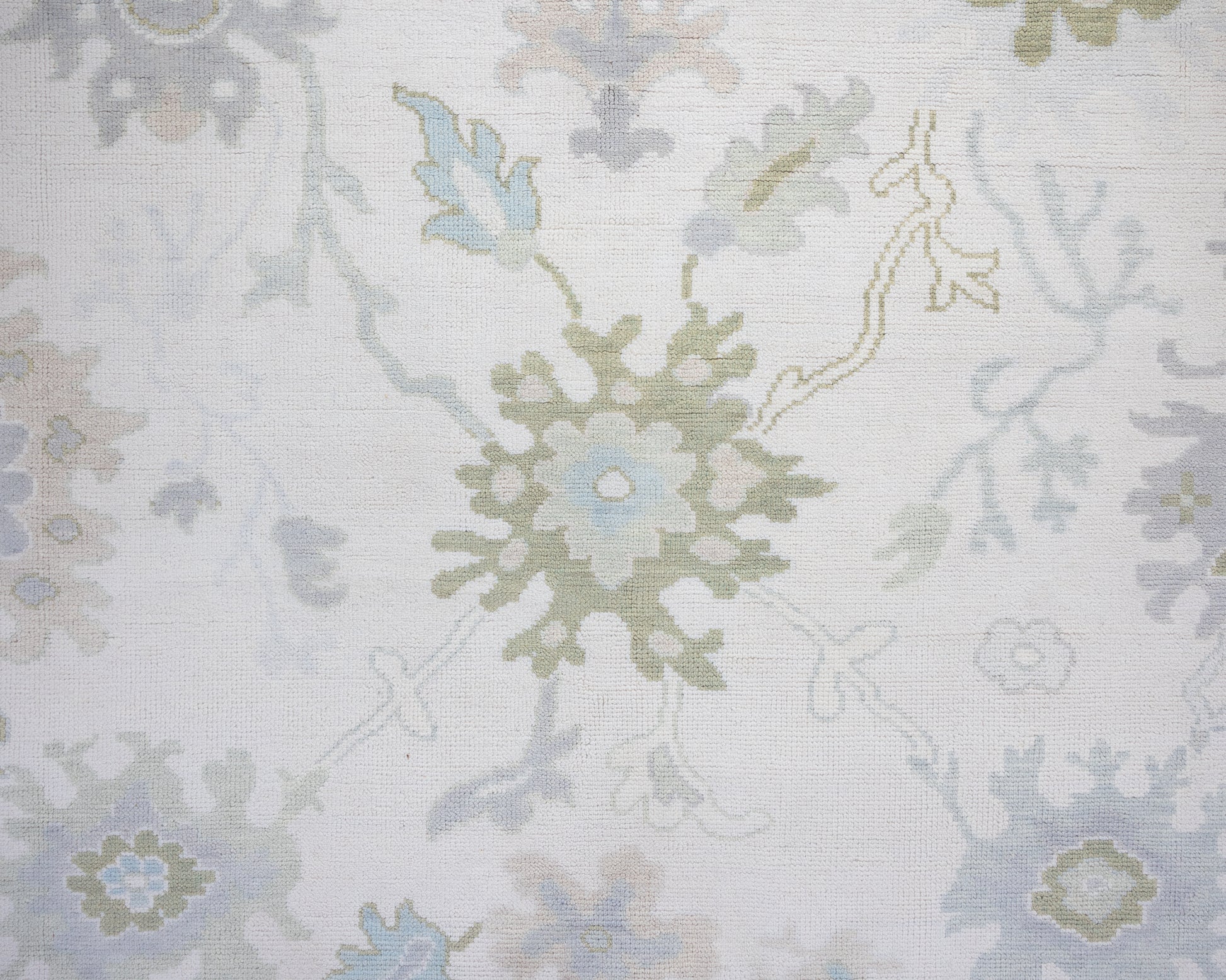 Opal hand-knotted wool rug in soft blue, blush, olive, and ivory from Locust Lane Rugs
