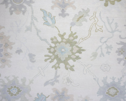 Opal hand-knotted wool rug in soft blue, blush, olive, and ivory from Locust Lane Rugs