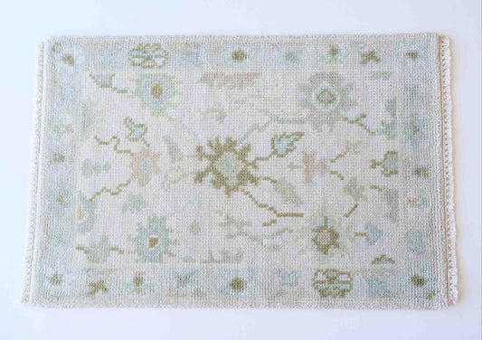 Hand-knotted wool rug with soft floral motifs in pale blue, sage, and ivory – Opal Mini Rug by Locust Lane Rugs
