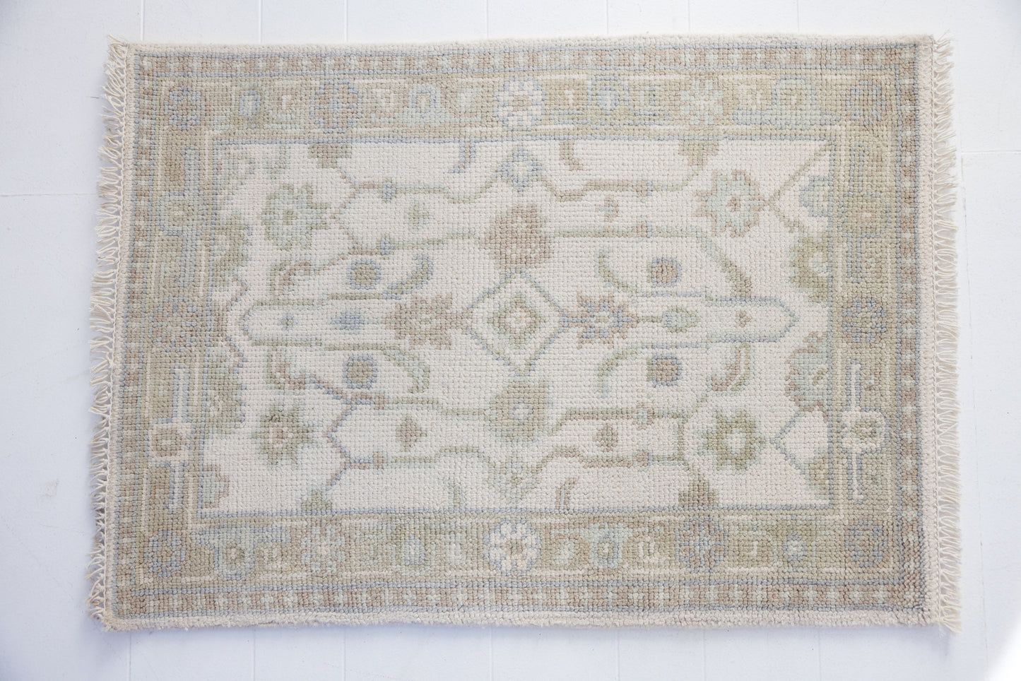 Hand-knotted wool rug with classic Oushak pattern in ivory, sky blue, and taupe – Pearl Mini Rug by Locust Lane Rugs