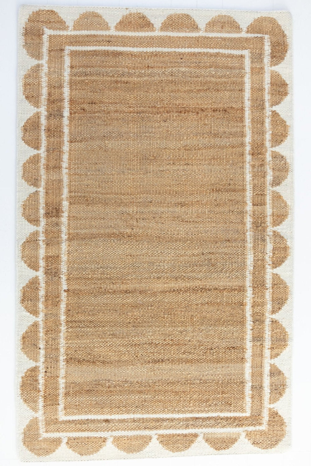 Handwoven jute and wool rug in natural tones with a crisp white scalloped border – White Scalloped Edge Rug by Locust Lane Rugs