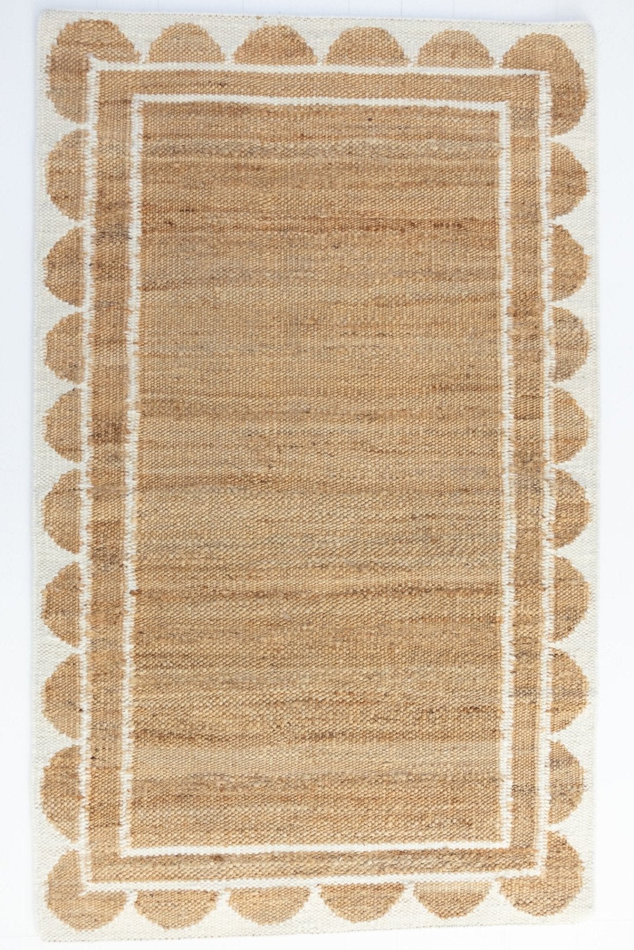 Handwoven jute and wool rug in natural tones with a crisp white scalloped border – White Scalloped Edge Rug by Locust Lane Rugs