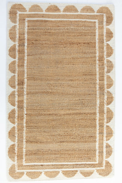 Handwoven jute and wool rug in natural tones with a crisp white scalloped border – White Scalloped Edge Rug by Locust Lane Rugs