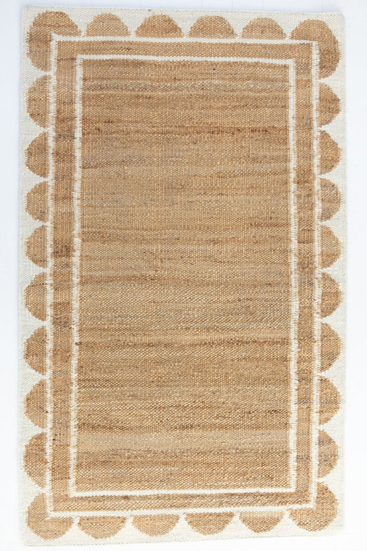 Handwoven jute and wool rug in natural tones with a crisp white scalloped border – White Scalloped Edge Rug by Locust Lane Rugs
